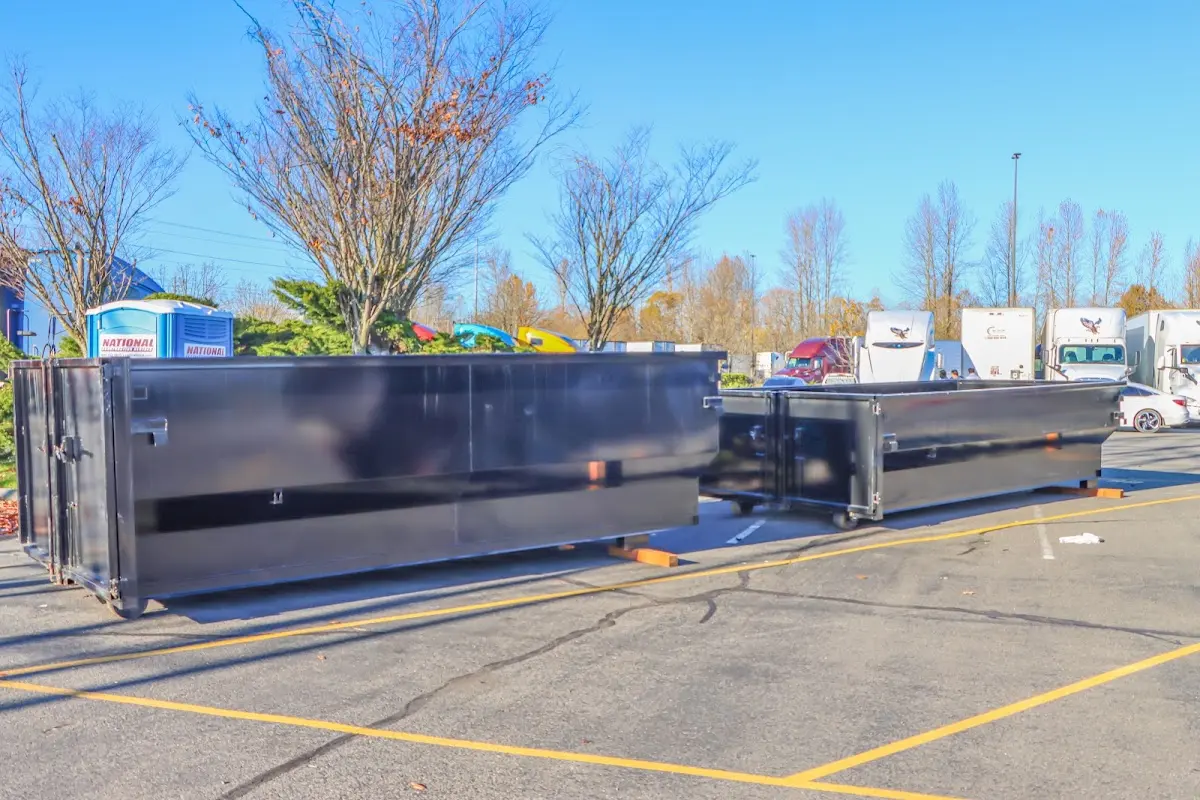 Professional dumpster rental service with roll-off container on residential driveway in Martinsville